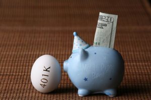 Piggy Bank Next to an Egg with 401K written on it